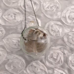 Unique necklace with feather inside glass ball